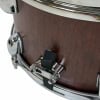 Close-up of Tama snare drum shell with chrome hardware.