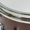 Close-up of chrome Tama Snare drum hoop with model engraving.