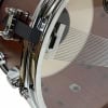 Close-up of Tama snare drum with chrome hardware and mesh snare.