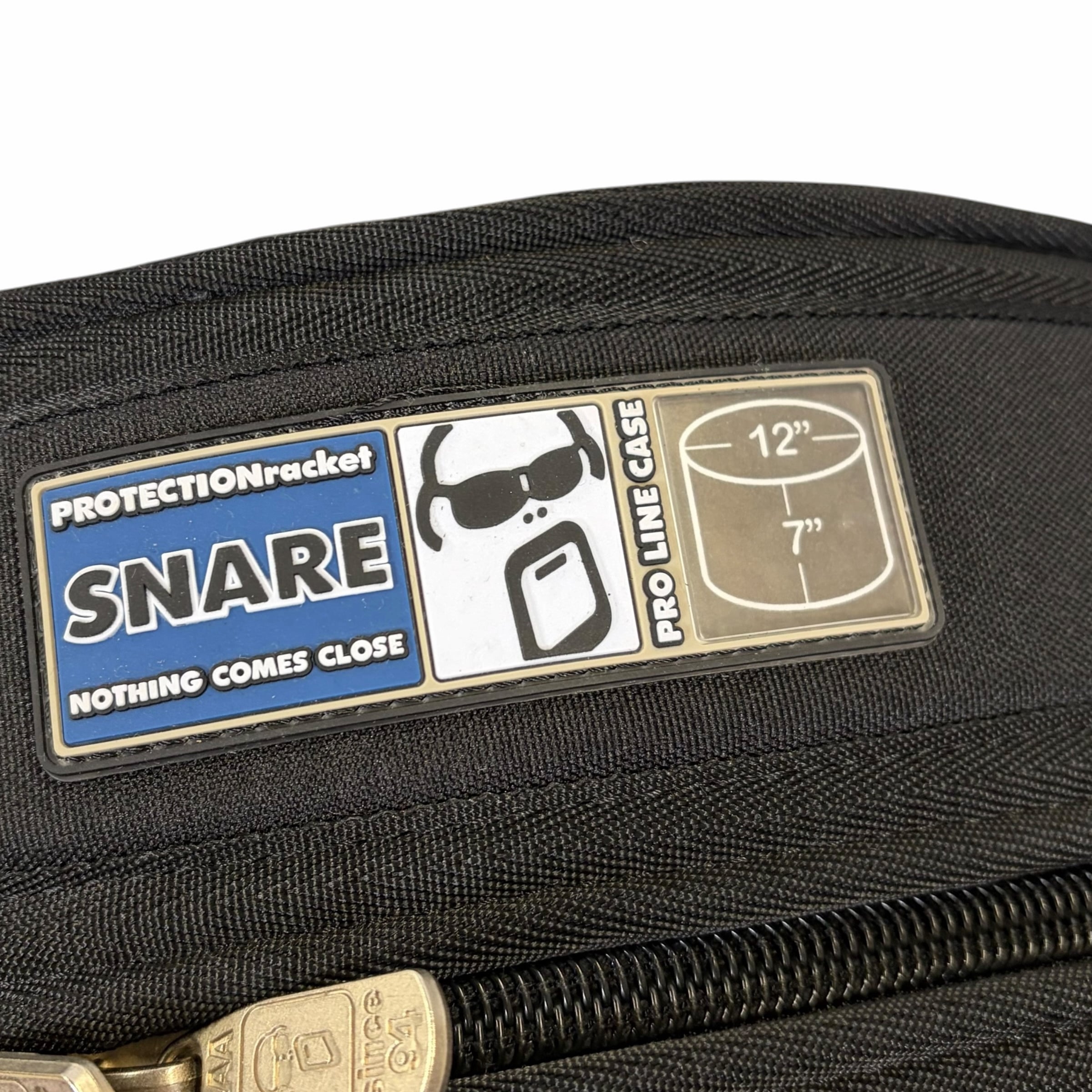 Pro Racket 12in snare case with protective snare badge on black bag.