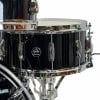Gretsch Renown Maple snare and drum hardware on a black drum set.