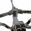 Shiny chrome drum stand joint with interlocking arms and central hub close-up.