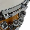 Mapex snare drum chrome hardware close-up with wooden shell and lugs.