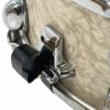 Close-up of chrome snare drum hardware with textured shell.
