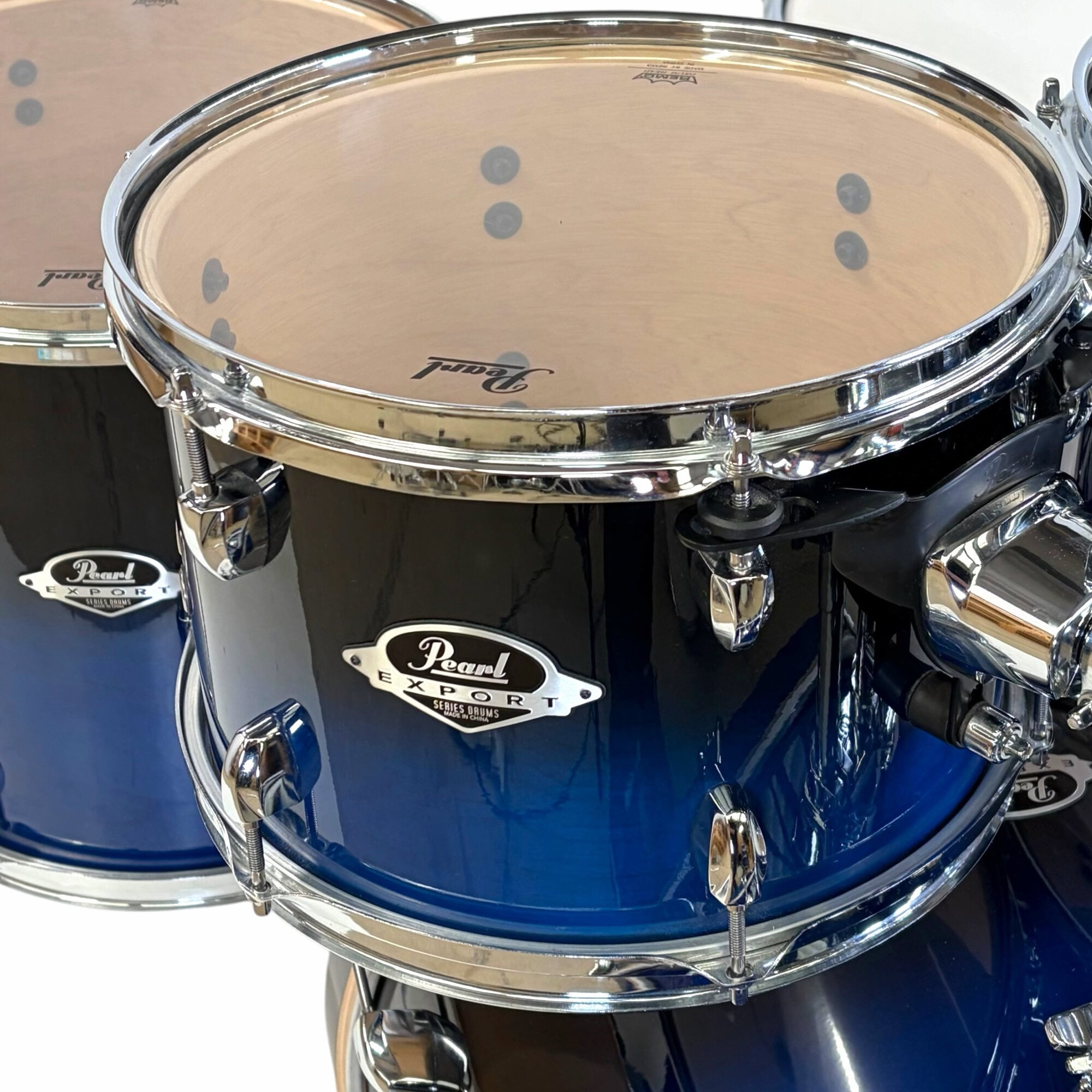 Blue Pearl Export drum shell with chrome hardware close-up.