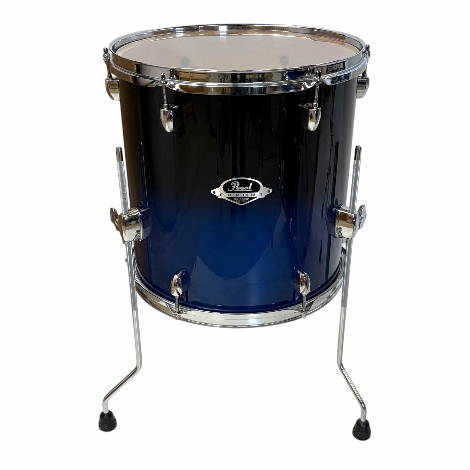 Pearl Export snare drum in dark blue finish with chrome hardware on a stand.