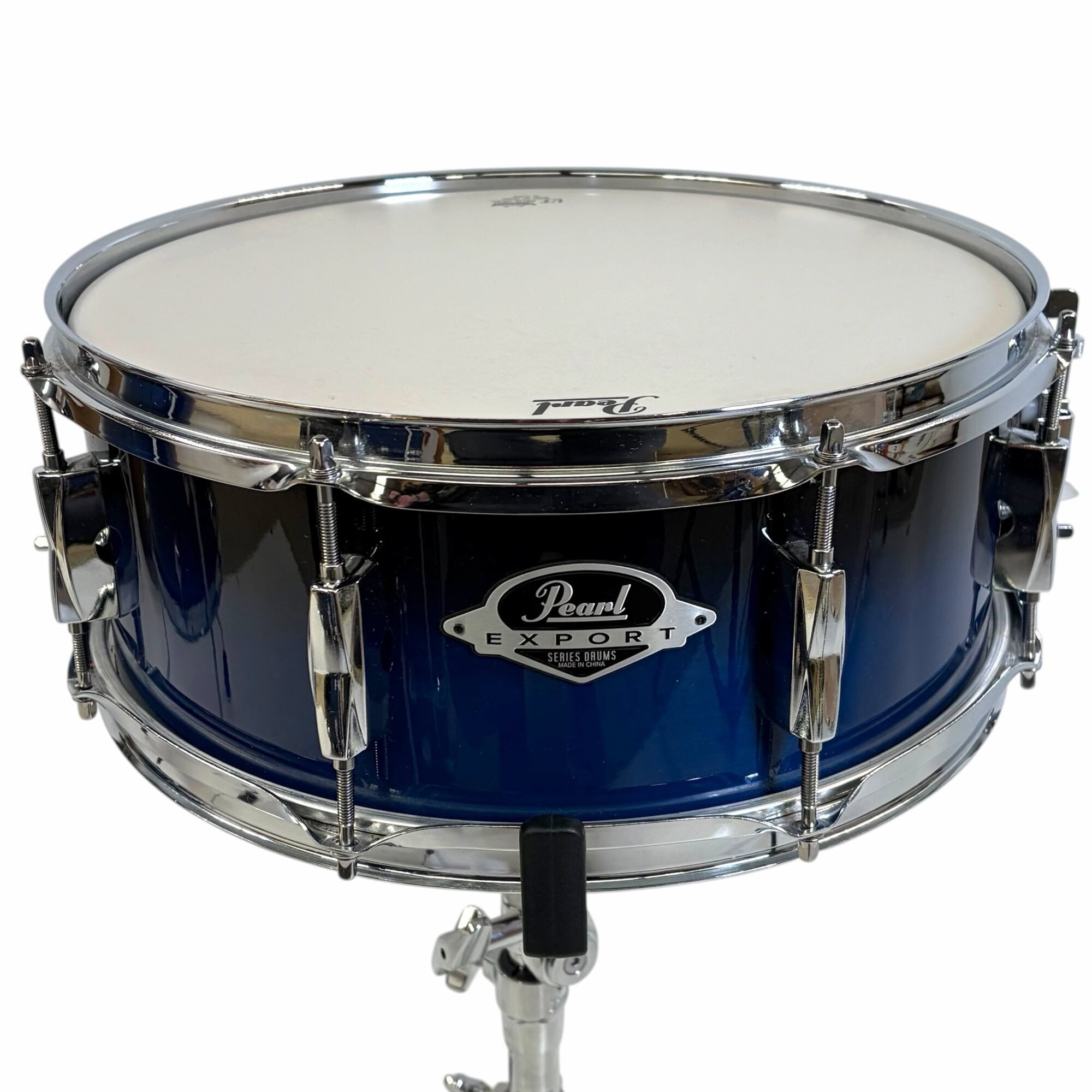 Pearl Export snare drum on chrome stand, blue finish, drum hardware.
