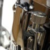 Close-up of drum hardware and tuning knob on a drum kit.