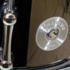 Close-up of Yamaha Tomahawk steel drum with engraved logo.