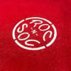 Drummers Only logo embroidered on red fabric for drum accessories.