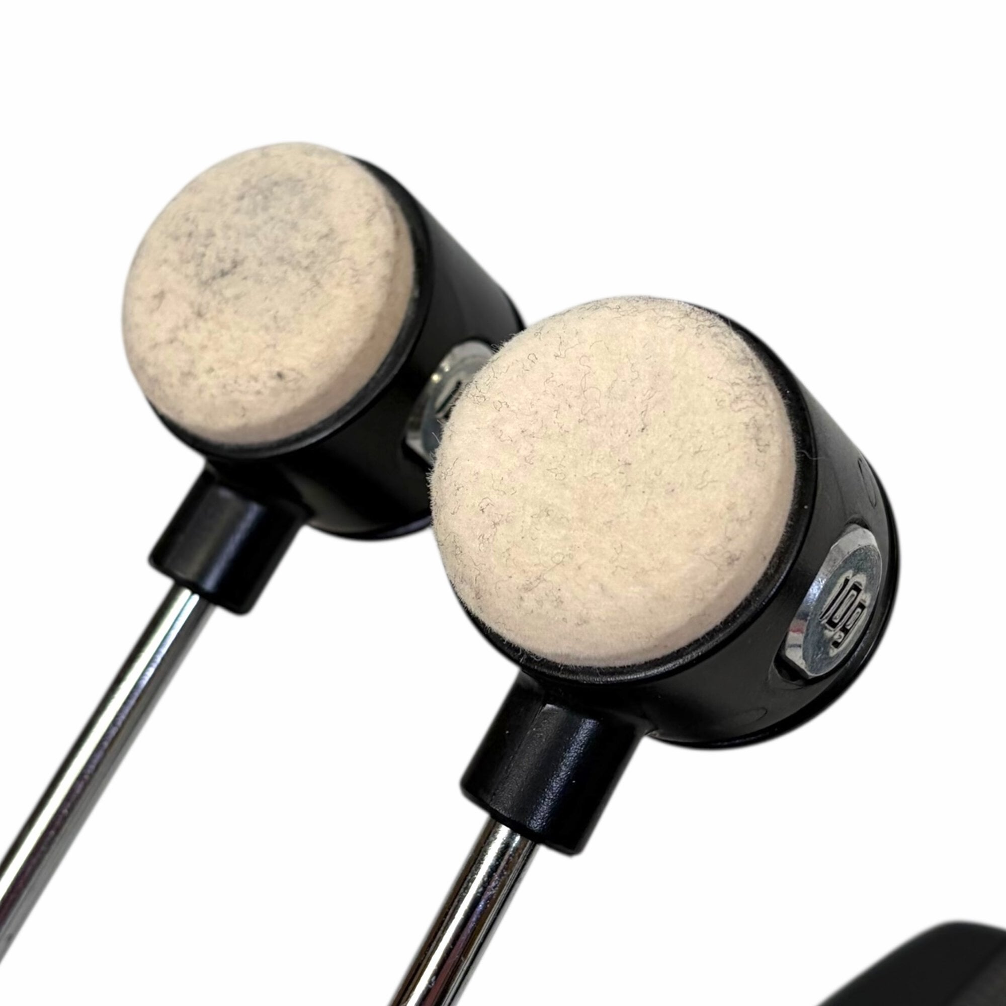 Close-up of drum pedal beaters for double bass drum setup.