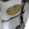Close-up of Pearl Sensitine Steel Snare Drum badge with custom alloy and steel shell.