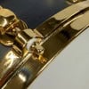 Close-up of a shiny gold saxophone with detailed keys and body.